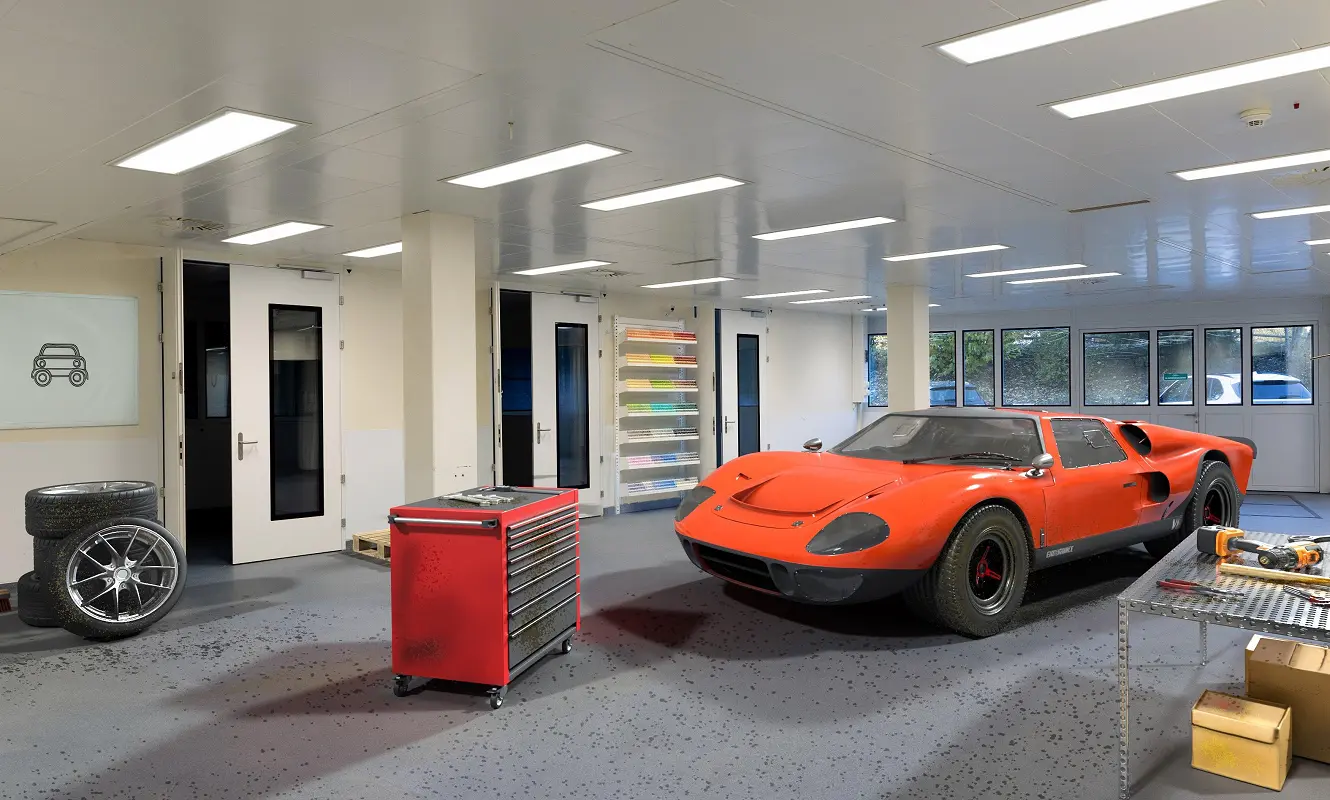 Fotomontage: leere Gewerbefläche im GWERB7 als Werkstatt inszeniert, mit rotem Sportwagen, Werkzeugwagen und Reifen